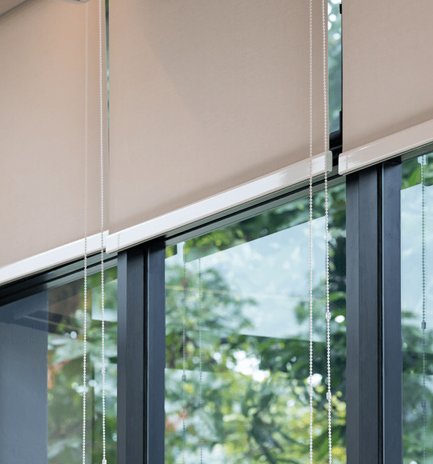 Window blinds with view of trees outside.
